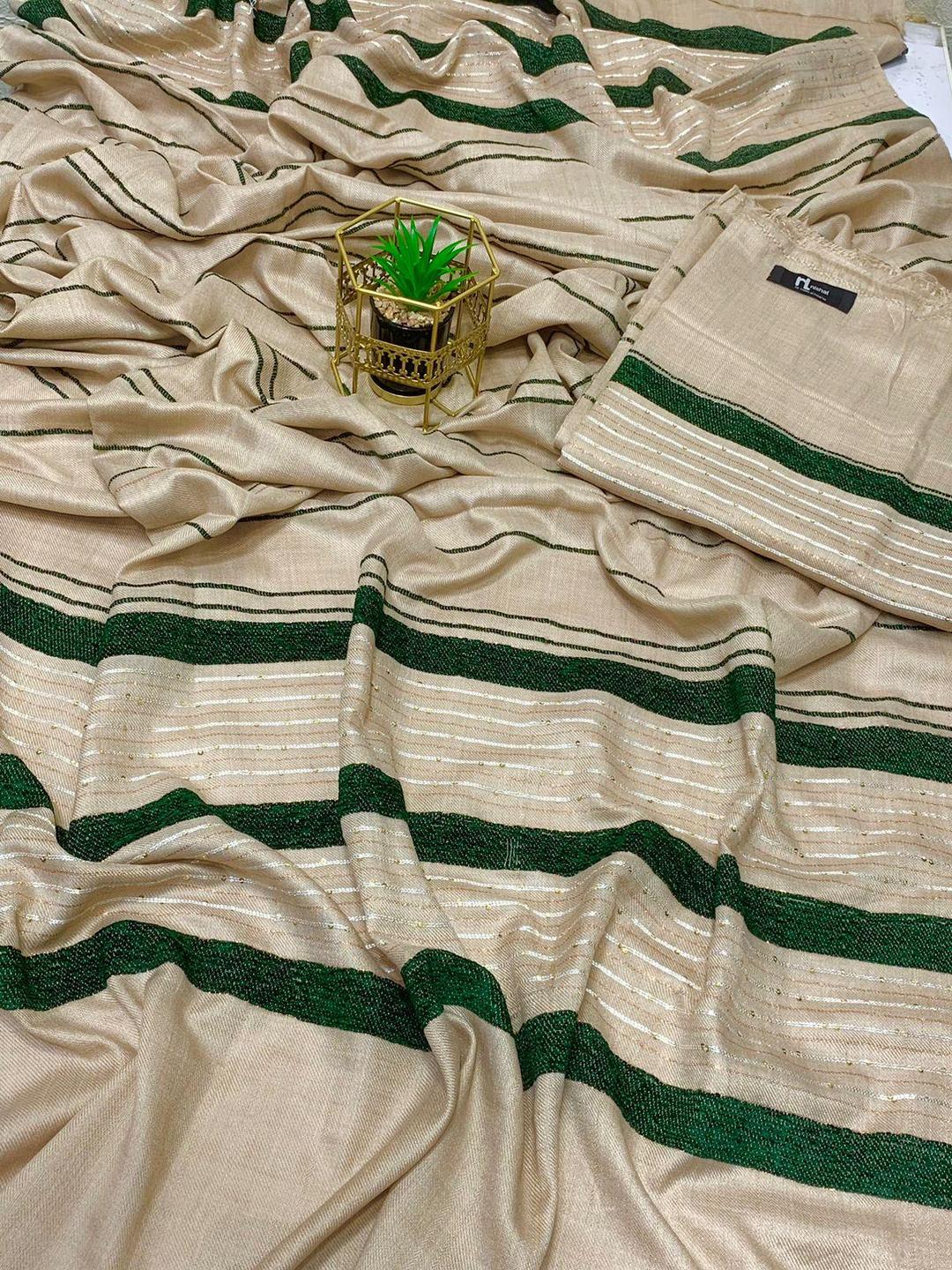 Beige saree with green stripes and a small potted plant in a golden holder