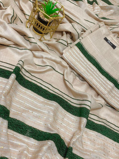 Beige saree with green and gold stripes, small potted plant on gold holder