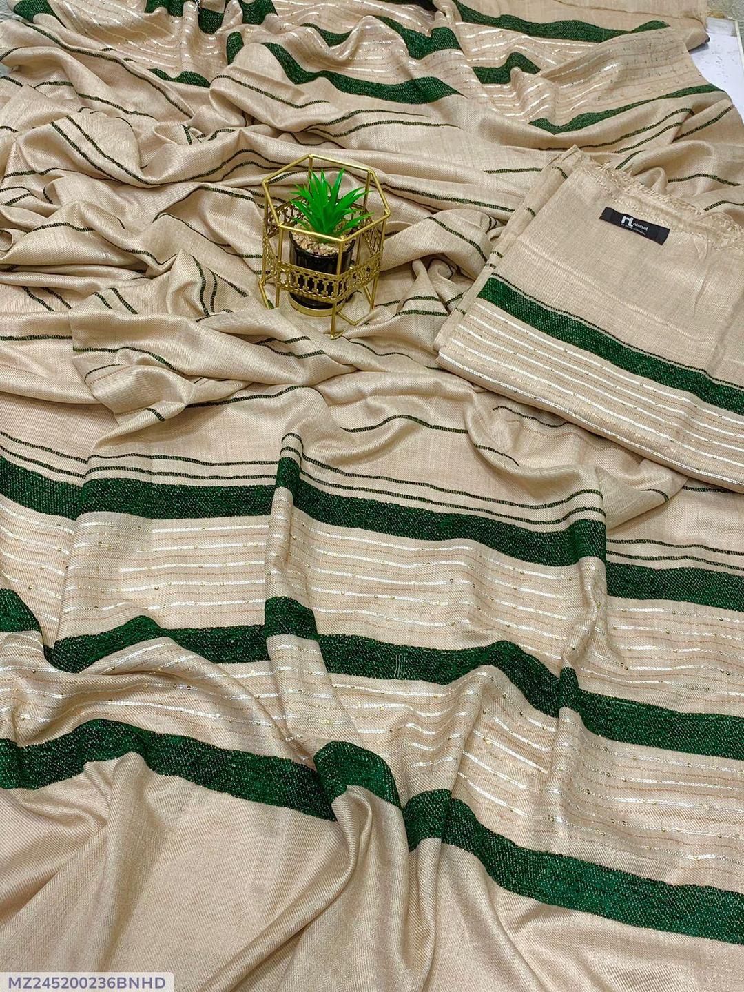 Beige saree with green and gold stripes, small potted plant decor on fabric
