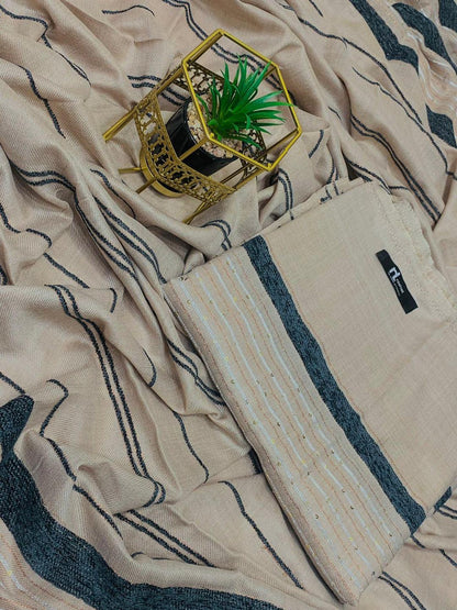 Beige and black patterned fabric with potted green plant in decorative gold holder