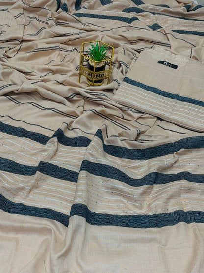 Beige and black striped saree fabric with a small potted plant on top