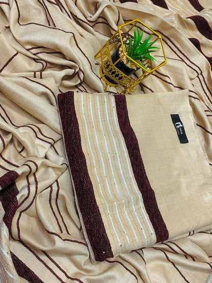 Beige and maroon striped saree with metallic thread detail, potted plant in gold holder