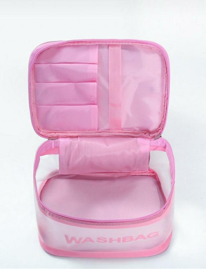 Open pink washbag with compartments, travel toiletry organizer on white background