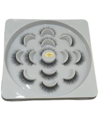 False eyelash pack with multiple pairs arranged in a circular white tray