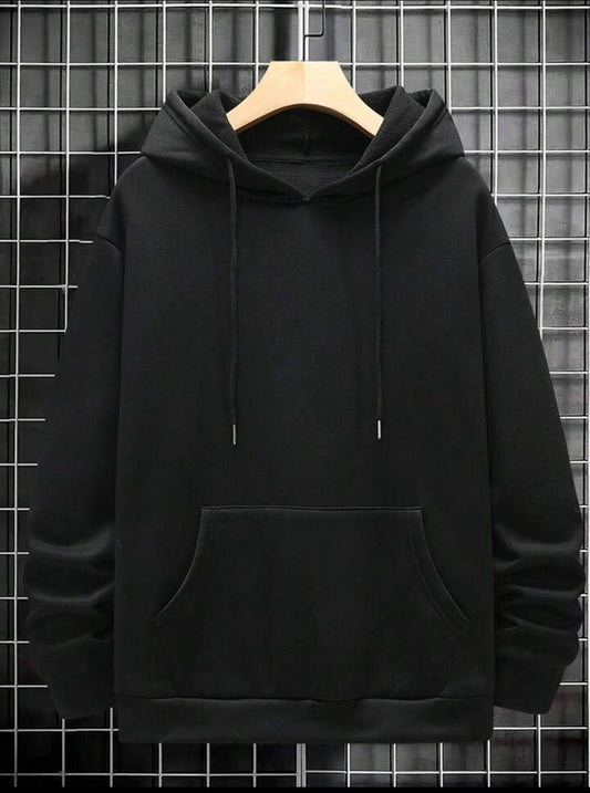 Black hoodie with front pocket and drawstrings displayed on hanger against grid wall