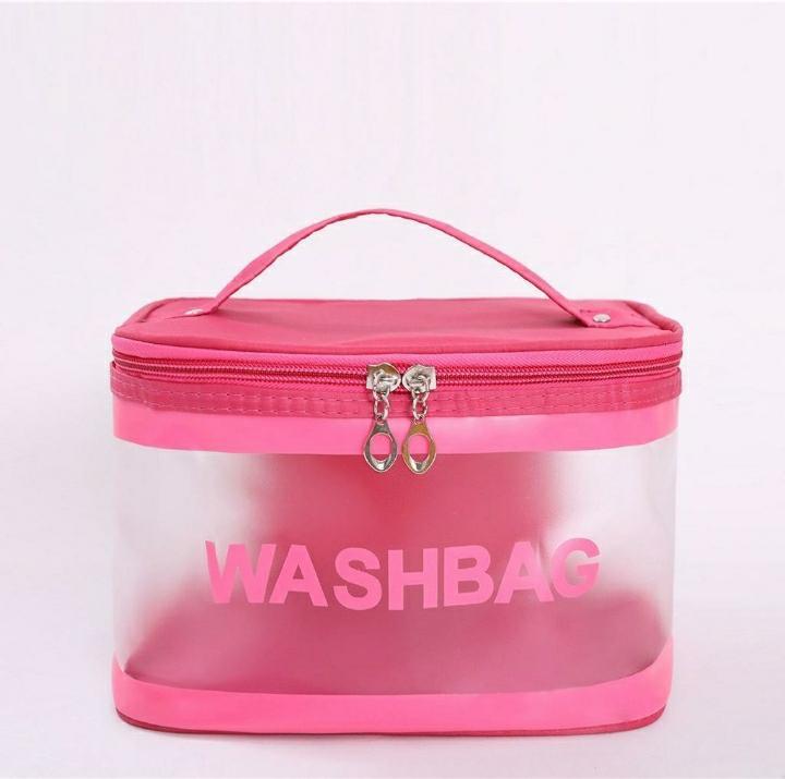 Pink transparent wash bag with zipper and handle on white background