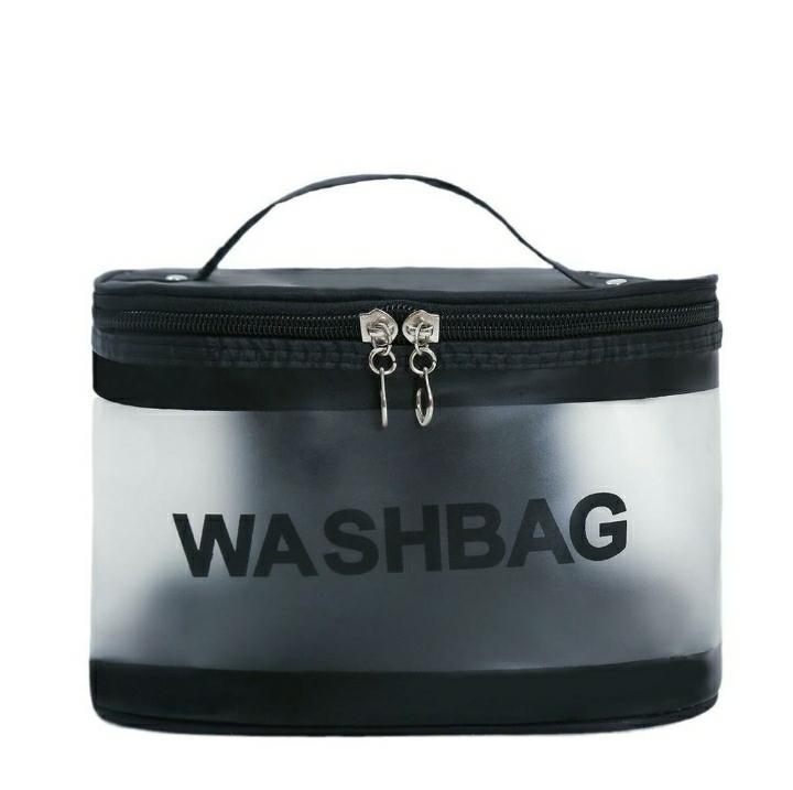 Clear zippered wash bag with black trim and handle, labeled WASHBAG, travel toiletry organizer