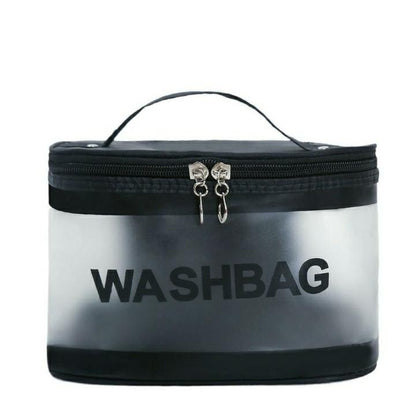 Clear zippered wash bag with black trim and handle, labeled WASHBAG, travel toiletry organizer