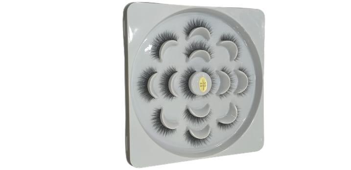 False eyelashes set in circular white tray for makeup and beauty