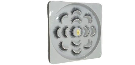 False eyelashes set in circular white tray for makeup and beauty