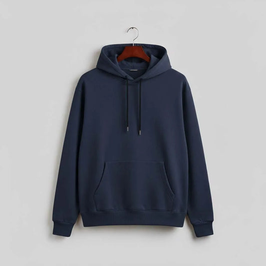 Navy blue pullover hoodie with front pocket and drawstrings on a hanger against a gray wall.