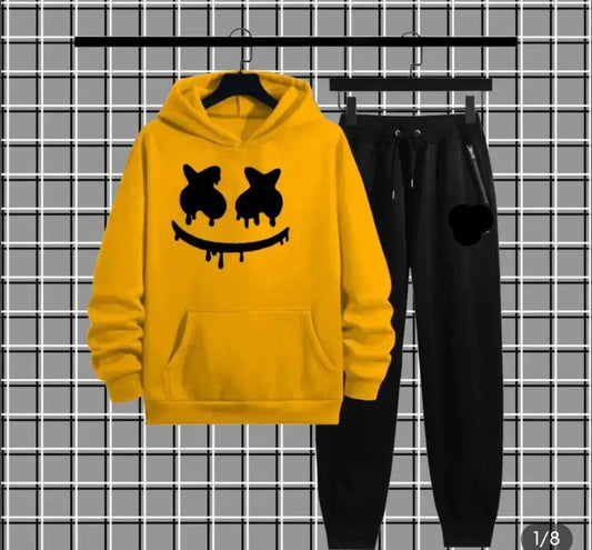 Yellow smiley face hoodie and black jogger pants set on plaid background