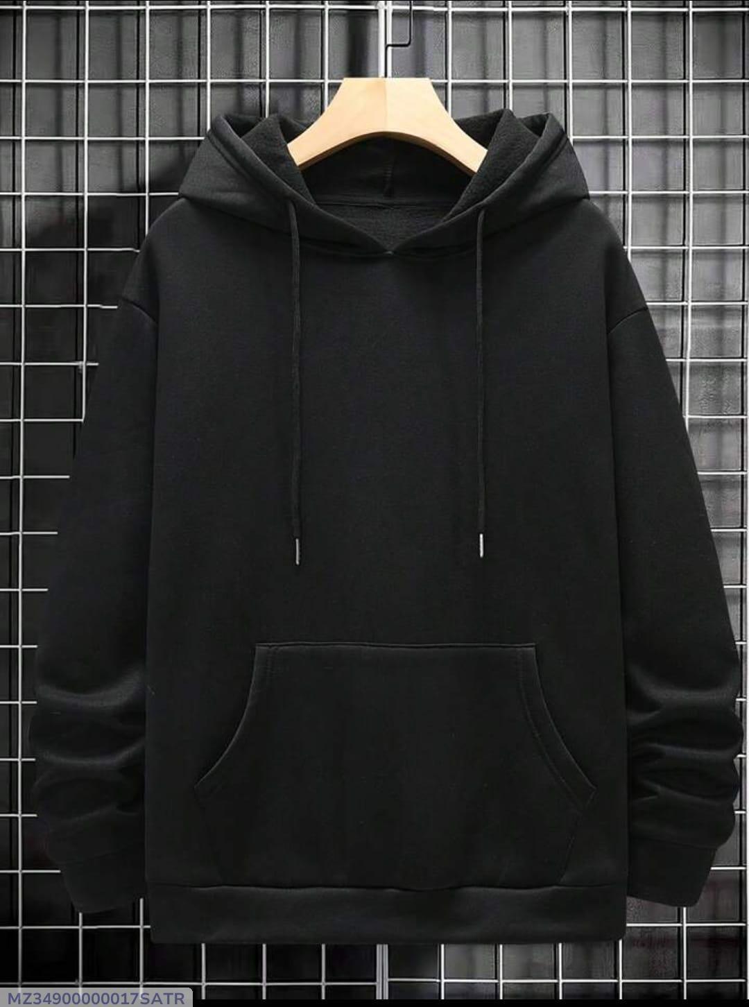Plain black hoodie with front pocket and drawstrings on hanger against grid wall