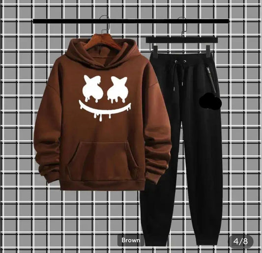 Brown hoodie with white dripping smiley face design and black jogger pants on hangers
