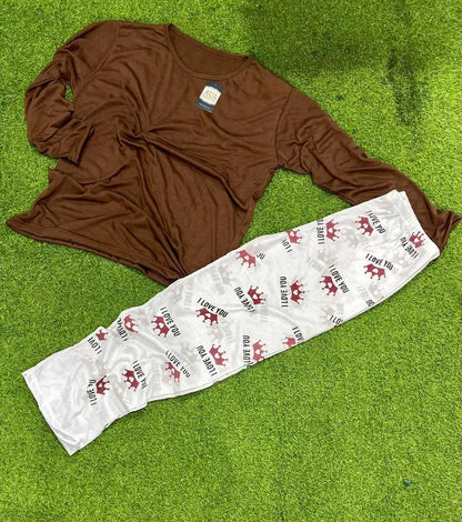 Brown long sleeve pajama top and white pants with red crowns and 'I love you' text on grass